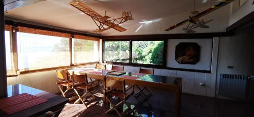 a room with a table and chairs and windows at Beach House Bella Vista apartments in Trogir