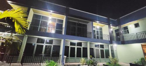 a blue and white building with a lot of windows at Pacific Land Guesthouse in Burega