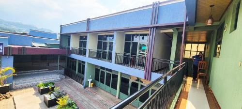a person is standing outside of a building at Pacific Land Guesthouse in Burega