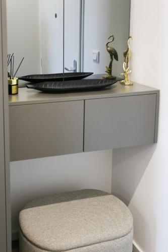 a desk with a mirror and a stool at Luxury City-Center Apartment in Bratislava - Parking Included in Bratislava
