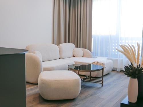 a living room with a couch and a table at Luxury City-Center Apartment in Bratislava - Parking Included in Bratislava