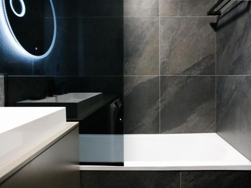 a bathroom with a sink and a mirror at Luxury City-Center Apartment in Bratislava - Parking Included in Bratislava