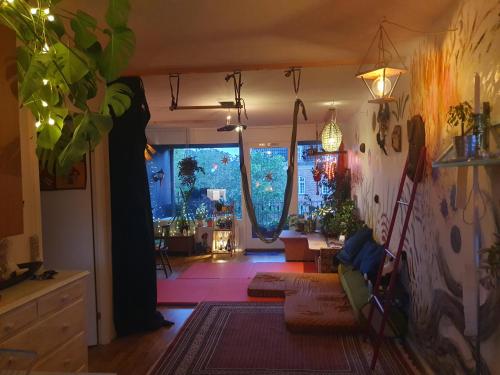 a living room with a large window and a room at Apartment and music studio in Copenhagen