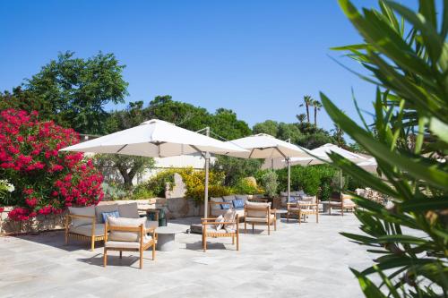 a row of tables and chairs with umbrellas at Mangia's Sardinia Resort - NEW OPENING in Santa Teresa Gallura