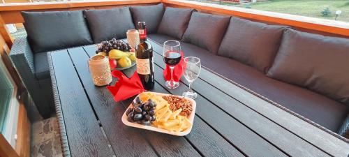a table with a tray of food and wine on a couch at Turda Retreat in Turda
