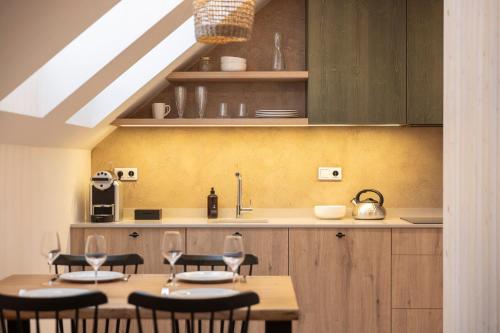 a kitchen with a table and chairs and a counter at Apartmány Hraničná s privátním wellness in Bedřichov