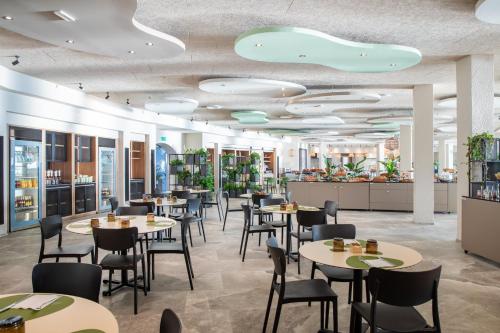a restaurant with tables and chairs and a bar at Mangia's Sardinia Resort - NEW OPENING in Santa Teresa Gallura