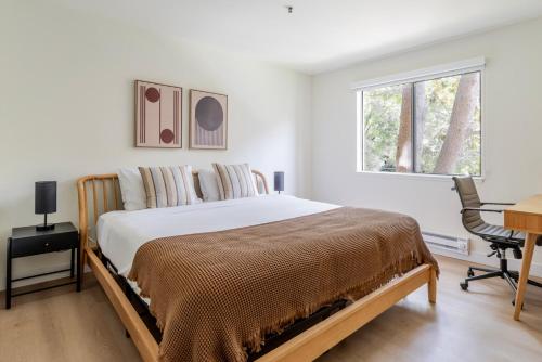 a bedroom with a bed and a desk and a window at Blueground Shoreline West pool nr Shoreline Park SFO-1857 in San Francisco