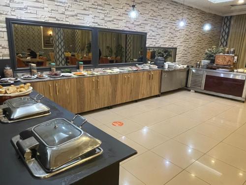 a large kitchen with a buffet in a restaurant at Madi Hotel Ankara in Altındağ