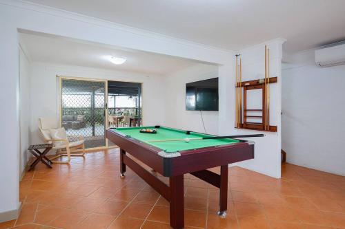 a living room with a pool table in it at The Lake Haus - Spacious Waterfront Escape with Pool in Karraganbah