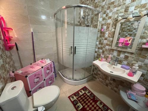 a bathroom with a shower and a toilet and a sink at Luxury couple room in irbid in Irbid