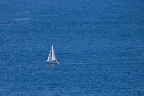 a small sail boat in the middle of the ocean at Incoming Municipio in Naples