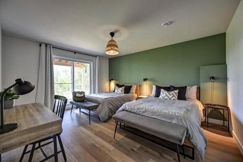 a bedroom with two beds and a table and a desk at Kensho Enjoy nature life with Hot tub in Sainte Béatrix