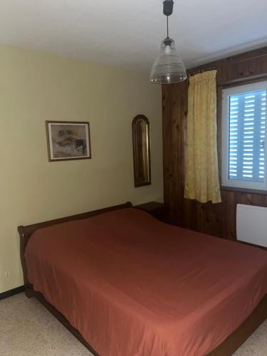 a bedroom with a bed and a window at La belle époque in Bourg-en-Bresse