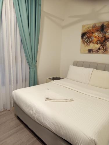 Ένα ή περισσότερα κρεβάτια σε δωμάτιο στο Agile KLCC Suites By TRX