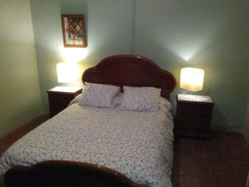 a bedroom with a bed with two lamps on it at Casa Rural Masía Barbera in Ibi