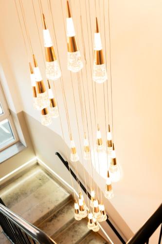 a chandelier hanging over a table with a chair at Hotel Heidelux in Soltau