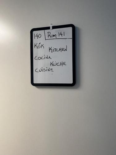 a sign on a wall with writing on it at Rentalux Hostel - Modern Comfort, Single Rooms in Timrå