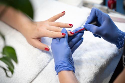 a woman getting a manicure at a nail salon at Lotus Therme Hotel & Spa in Hévíz