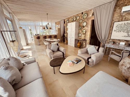 a living room filled with furniture and a fireplace at Villa Il Carrubo val di noto con piscina privata in Avola