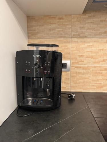 a coffee maker sitting on top of a counter at Dardania Hostel in Peje
