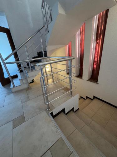 a staircase with a metal railing in a building at Dardania Hostel in Peje