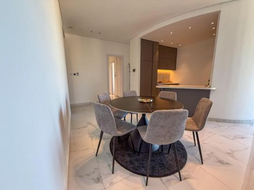 a kitchen and dining room with a table and chairs at The 1 -Nicosia Luxe Stay- Gym Pool 24h Concierge in Nicosia