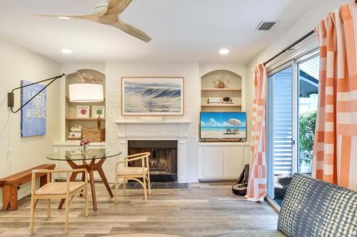 a living room with a table and a fireplace at Island Square 145 in Saint Simons Island