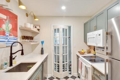 a kitchen with white counters and a refrigerator at Island Square 145 in Saint Simons Island