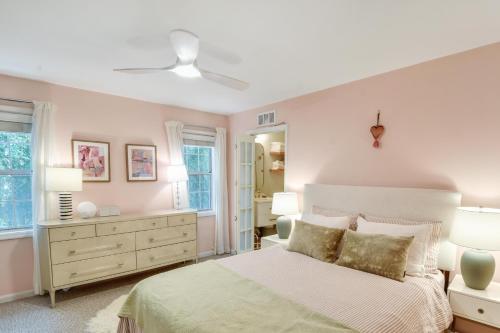 a bedroom with a bed and two lamps and a dresser at Island Square 145 in Saint Simons Island