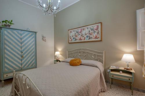 a bedroom with a bed and a chandelier at Casa Degli Zii in Salento in Trepuzzi
