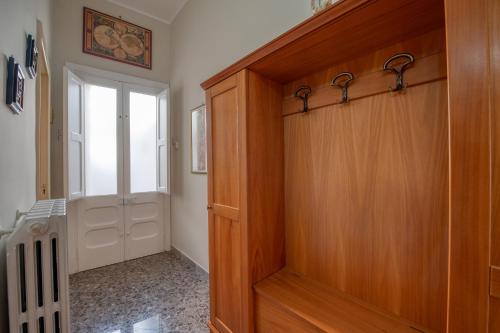 a hallway with a wooden door and a window at Casa Degli Zii in Salento in Trepuzzi