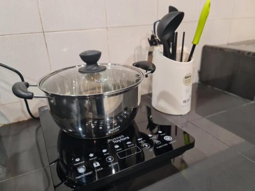 a pot on top of a stove in a kitchen at 10pax BAYU BEACH, SEASIDE, WATERSPORT, Pool, Bbq, Wifi, 50"TV in Port Dickson