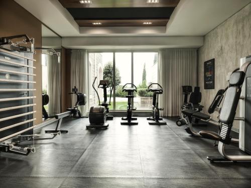 a gym with several tread machines and a large window at The Chedi Luštica Bay in Tivat