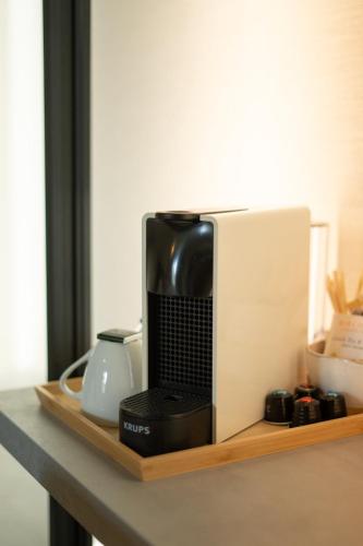 a coffee maker sitting on a wooden shelf at Hótel Skógafoss by EJ Hotels in Skogar