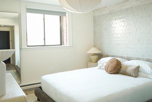 a bedroom with a white bed and a window at The Bow Hotel in Portsmouth