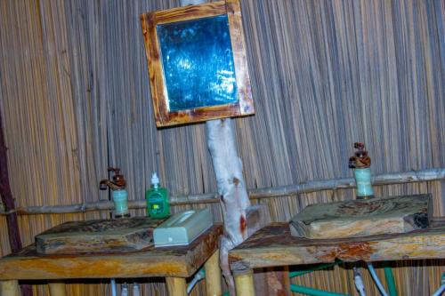 a room with two beds and a mirror on the wall at Amanya Star Bed Amboseli in Amboseli