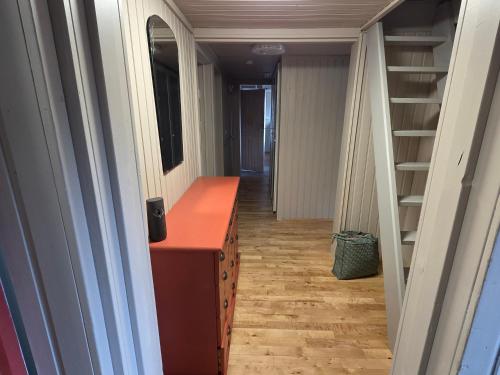 a hallway with a dresser and a staircase in a room at Holavegur 1 in Úthlid