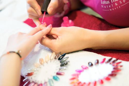 a girl getting her nails done at a salon at Lotus Therme Hotel & Spa in Hévíz