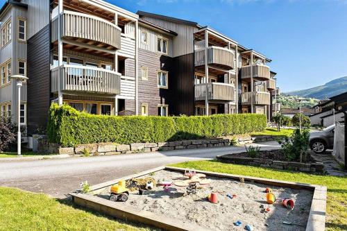 an apartment building with a sandbox in the middle of a street at Central Apartment with a View in Vossevangen