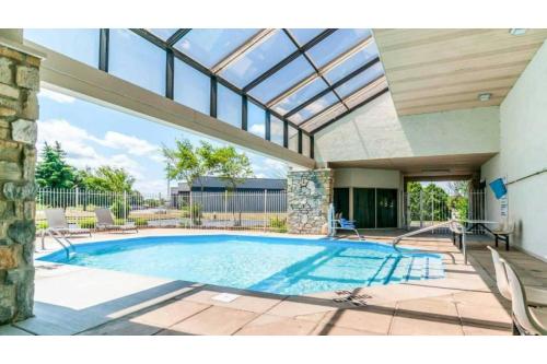an indoor swimming pool with a glass roof at Studio 6 Southgate MI Detroit in Southgate