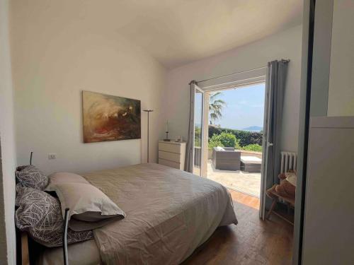 a bedroom with a bed and a door to a patio at Charming Villa with stunning sea views in Mougins