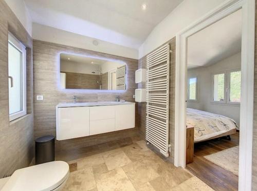 a bathroom with a bed and a sink and a mirror at Charming Villa with stunning sea views in Mougins