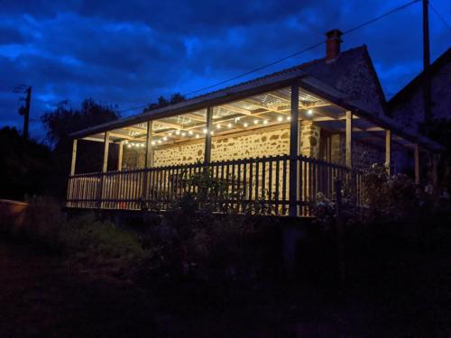 a house lit up at night with lights at Le Gîte du Bocage in Céaucé