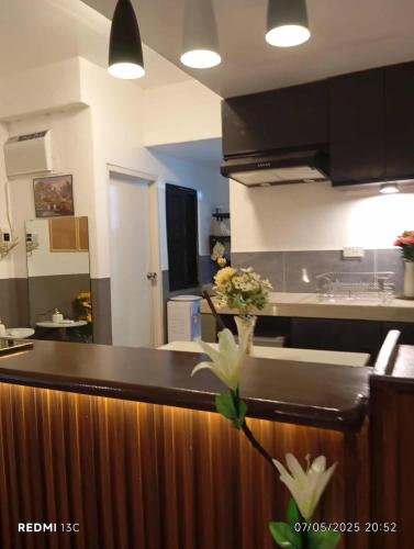 a kitchen with a counter with flowers on it at Parayno's Residence in Marikina 2 in Manila