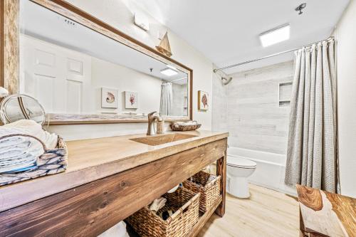 a bathroom with a sink and a mirror at Updated direct oceanfront condo with large private balcony and a beachfront pool in New Smyrna Beach