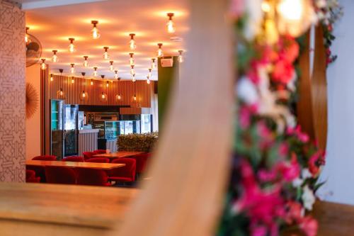 a view of a restaurant with red chairs and lights at Sleephotels Cosmos in Hamburg