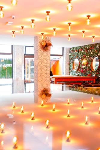 a group of candles in a room with a christmas tree at Sleephotels Cosmos in Hamburg