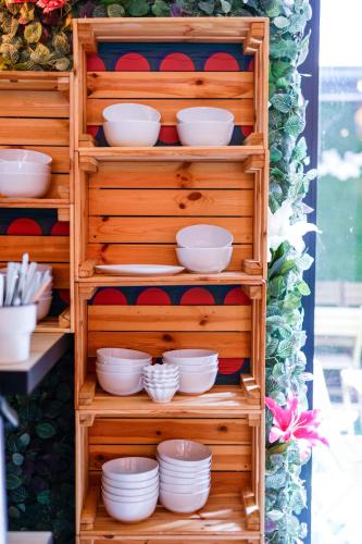 a wooden shelf with white dishes on it at Sleephotels Cosmos in Hamburg