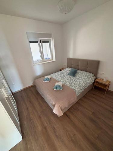 a bedroom with a bed with two pillows on it at Apartment Ivi, Omis in Omiš